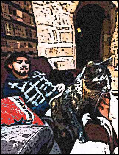 Hombre meditabundo en un sofá con un gato en sus piernas.